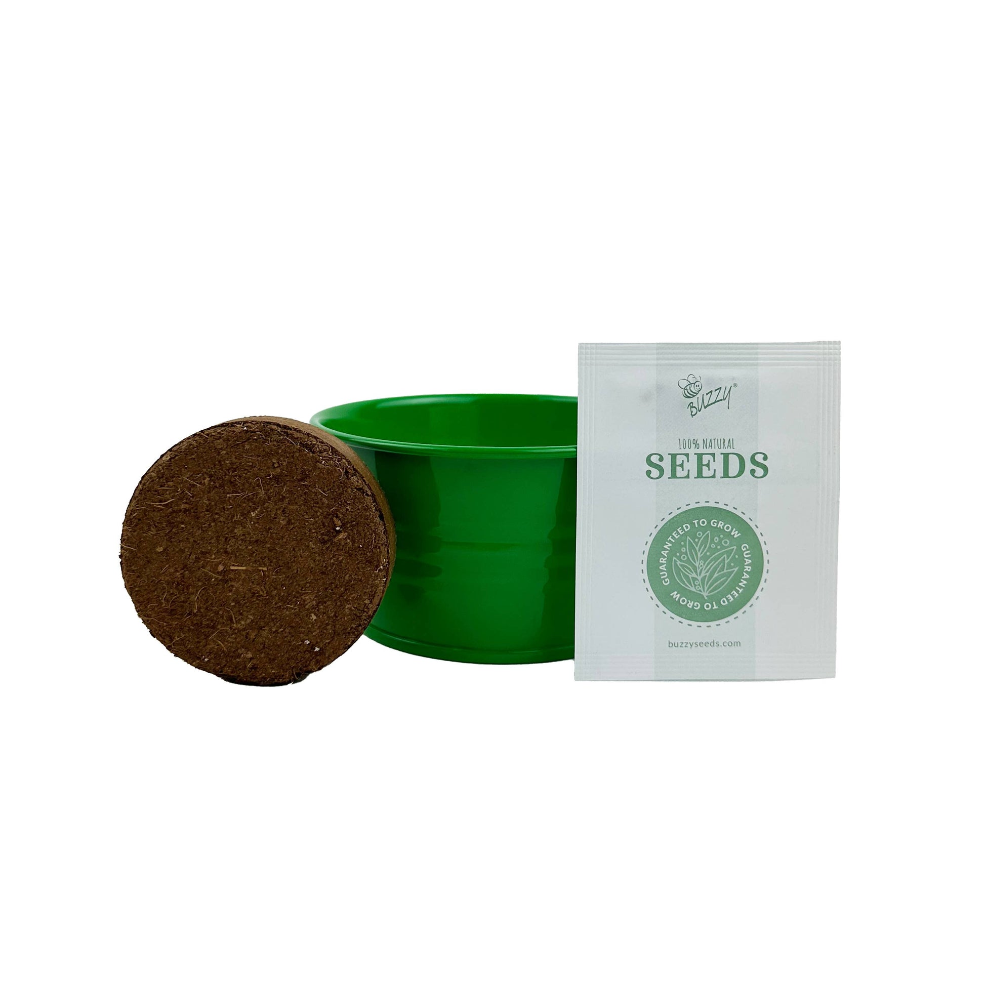 Green seedling pot, brown coir block, and white seed packet on a white background