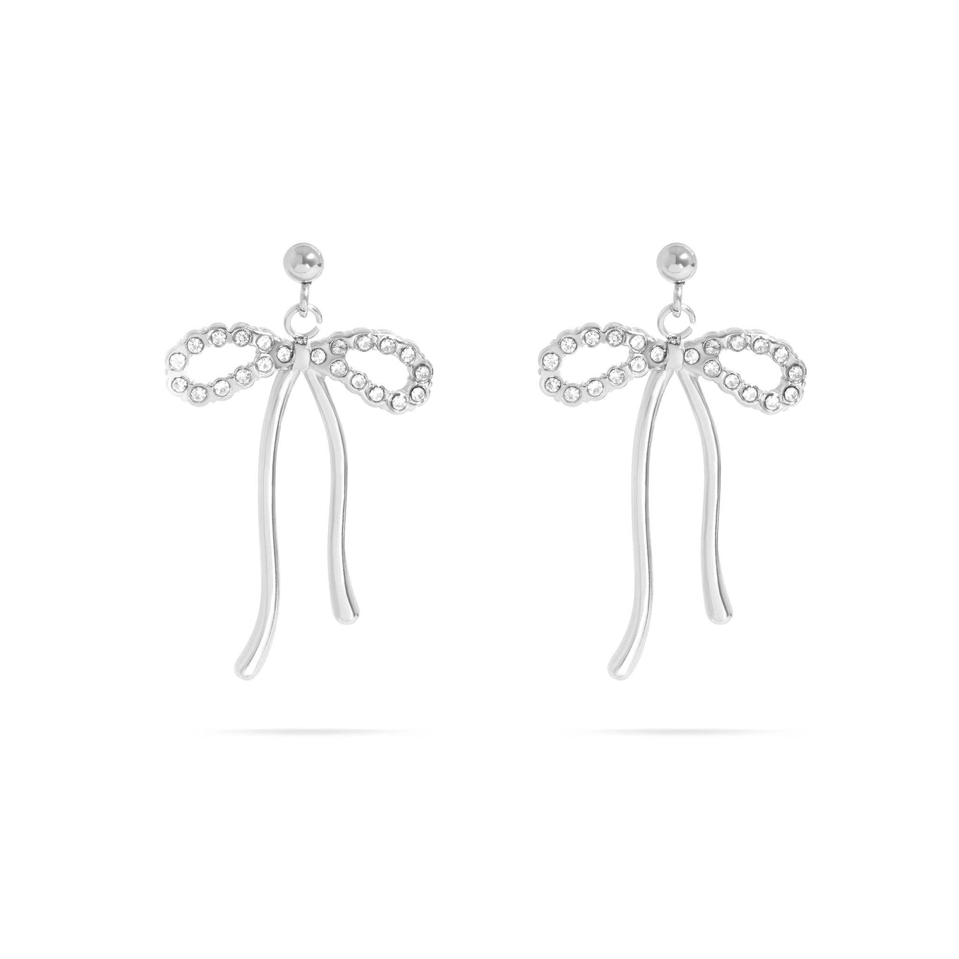 A pair of silver bow-shaped drop earrings embellished with small clear rhinestones, shown on a plain white background.