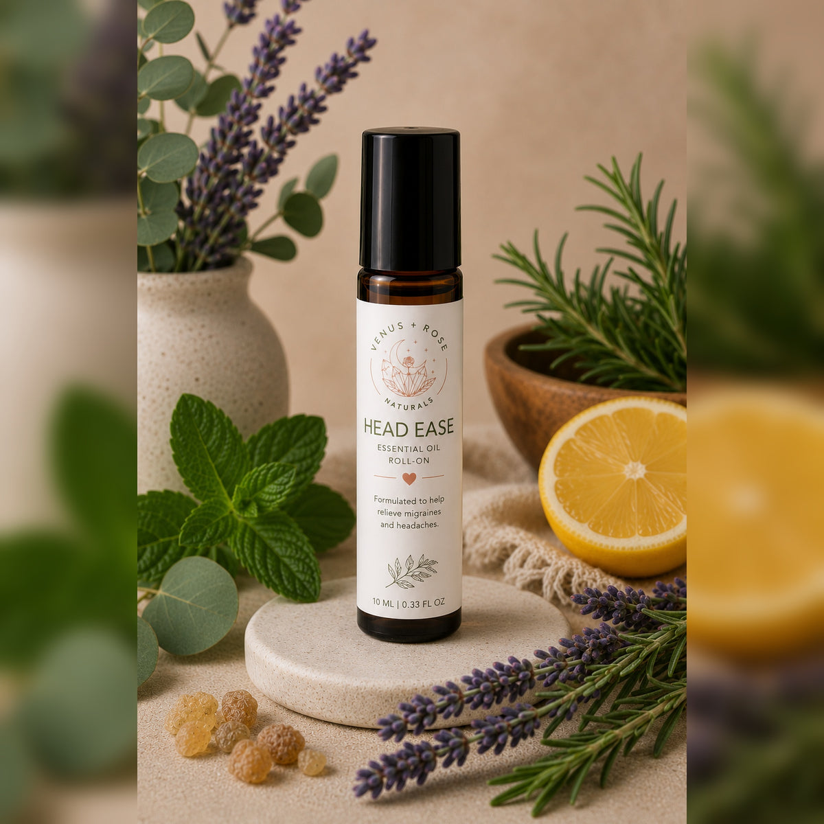 A bottle of Head Ease Essential Oil Oil by Lavender & Rose Naturals, styled on a stone coaster with lavender, mint, rosemary, and a lemon slice against a warm beige background.